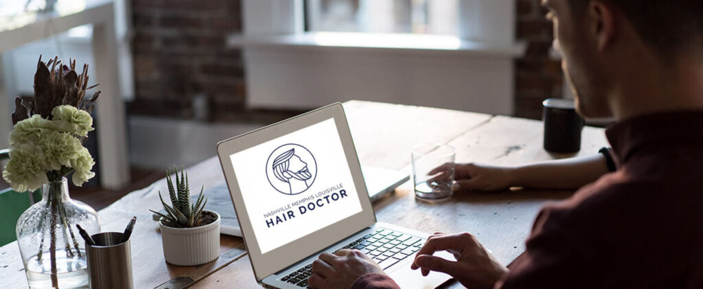 Nashville Hair Doctor logo on a laptop screen.