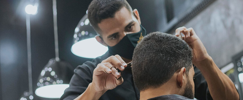 Man cutting someone's hair in Nashville, TN.