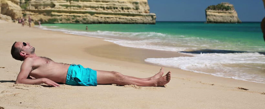 Man at the beach in the summer.