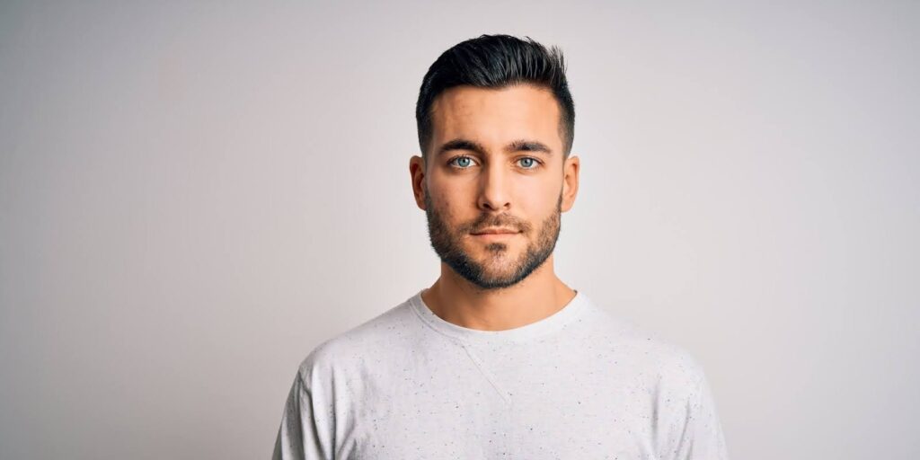 A man with a beard looking serious.