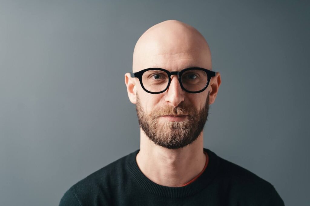 Close-up portrait smiling bearded young man